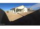 A backyard with a covered patio, surrounded by block wall fencing, and desert landscaping at 26293 W Desert Crest St, Casa Grande, AZ 85193