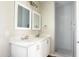 Bathroom with double vanity, frameless shower, and white cabinets at 26293 W Desert Crest St, Casa Grande, AZ 85193