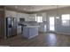 Bright open kitchen with white cabinets, stainless steel appliances, and a center island at 26293 W Desert Crest St, Casa Grande, AZ 85193