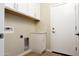 Bright laundry room with white cabinets and built-in storage at 26293 W Desert Crest St, Casa Grande, AZ 85193