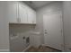 Laundry room with white cabinets and a door to the outside at 26293 W Desert Crest St, Casa Grande, AZ 85193