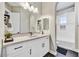 Modern bathroom with white cabinets, a large mirror and neutral tones at 3190 S Jacaranda Ct, Gold Canyon, AZ 85118