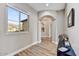Bright hallway with arched entryways and wood flooring at 3190 S Jacaranda Ct, Gold Canyon, AZ 85118