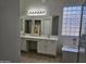 Bathroom with double vanity, glass block window, and tub at 4072 S Skyline Ct, Gilbert, AZ 85297
