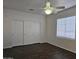 Bedroom featuring dark flooring, large closet, and ceiling fan at 4072 S Skyline Ct, Gilbert, AZ 85297