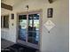 Exterior of the clubhouse featuring double glass doors and community signage at 4072 S Skyline Ct, Gilbert, AZ 85297