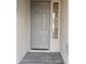 Front entry with gray door and sidelight window at 4072 S Skyline Ct, Gilbert, AZ 85297