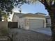Attached garage with gray door and stone accents at 4072 S Skyline Ct, Gilbert, AZ 85297