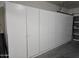 Garage with built-in white cabinets for storage at 4072 S Skyline Ct, Gilbert, AZ 85297