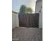 Backyard access with brown wooden gate at 4072 S Skyline Ct, Gilbert, AZ 85297