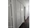 White hallway closet with gold knobs and dark wood floors at 4072 S Skyline Ct, Gilbert, AZ 85297