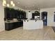 Kitchen with dark cabinets, granite countertops, and island at 4072 S Skyline Ct, Gilbert, AZ 85297