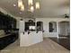 Modern kitchen with dark cabinetry and granite island at 4072 S Skyline Ct, Gilbert, AZ 85297