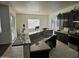 Island kitchen with granite countertops and dark wood cabinets at 4072 S Skyline Ct, Gilbert, AZ 85297