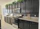 Kitchen with dark cabinets, granite counters, and stainless steel appliances at 4072 S Skyline Ct, Gilbert, AZ 85297