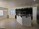 Open kitchen boasts granite countertops, dark cabinetry, and a large island at 4072 S Skyline Ct, Gilbert, AZ 85297