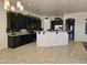 Open kitchen with dark cabinets and granite countertops at 4072 S Skyline Ct, Gilbert, AZ 85297