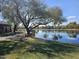 Picturesque community pond featuring a tranquil setting with walking paths and lush greenery at 4072 S Skyline Ct, Gilbert, AZ 85297