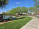 Beautiful community pond with a walking path and manicured lawn, offering a serene environment at 4072 S Skyline Ct, Gilbert, AZ 85297