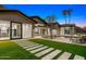 Modern backyard oasis with pool, grassy area, and stone pathways at 4129 E Sandy Mountain Rd, Paradise Valley, AZ 85253