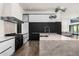 Modern kitchen with a large island, stainless steel appliances, and dark cabinetry at 4129 E Sandy Mountain Rd, Paradise Valley, AZ 85253