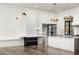 Bright kitchen features white cabinetry, marble island, and unique lighting fixtures at 4129 E Sandy Mountain Rd, Paradise Valley, AZ 85253