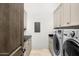 Convenient laundry room with washer, dryer, and ample cabinet space at 4129 E Sandy Mountain Rd, Paradise Valley, AZ 85253