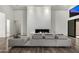 Open living area with large sectional sofa and linear fireplace at 4129 E Sandy Mountain Rd, Paradise Valley, AZ 85253
