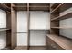 Large walk-in closet with custom built-in shelving and rods at 4129 E Sandy Mountain Rd, Paradise Valley, AZ 85253