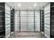 Modern wine cellar with sleek metal racking and glass enclosure at 4129 E Sandy Mountain Rd, Paradise Valley, AZ 85253