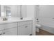 Bright bathroom with double vanity, white subway tile in shower, and wood-look tile flooring at 42103 N Cutbow Trl, San Tan Valley, AZ 85140