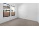 Bedroom with carpet, two windows, neutral paint, and modern trim at 42103 N Cutbow Trl, San Tan Valley, AZ 85140
