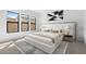 Modern primary bedroom featuring a stylish bed frame, neutral color palette, and black grid artwork at 42103 N Cutbow Trl, San Tan Valley, AZ 85140