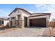 Attractive stucco home with stone pillar accents, two car garage, and desert landscaping at 42103 N Cutbow Trl, San Tan Valley, AZ 85140