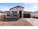 Beautiful single-story home with desert landscaping, stone accents, and a two-car garage at 42103 N Cutbow Trl, San Tan Valley, AZ 85140
