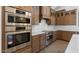 Gourmet kitchen featuring stainless steel appliances, double ovens, and custom cabinetry at 42103 N Cutbow Trl, San Tan Valley, AZ 85140