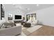 Bright living room with hardwood floors, white furniture, and a flat screen television at 42103 N Cutbow Trl, San Tan Valley, AZ 85140