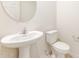 Stylish powder room with pedestal sink and toilet at 42835 W Peters Dr, Maricopa, AZ 85138