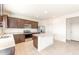 Spacious kitchen with dark cabinetry, granite countertops, and stainless steel appliances at 42835 W Peters Dr, Maricopa, AZ 85138