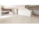 Open living room with tile floors and access to the kitchen at 42835 W Peters Dr, Maricopa, AZ 85138