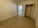 Simple bedroom with tile floors and a closet at 5019 W Roma Ave, Phoenix, AZ 85031