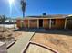 House exterior featuring a walkway to the front door and a palm tree at 5019 W Roma Ave, Phoenix, AZ 85031