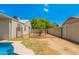 Partially fenced backyard with a small tree and space for gardening at 5648 W Folley St, Chandler, AZ 85226