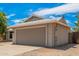 Side view of the house with a two-car garage and desert landscaping at 5648 W Folley St, Chandler, AZ 85226
