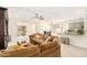 Open concept living room with brown sectional and kitchen access at 5648 W Folley St, Chandler, AZ 85226