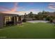 Turf backyard with putting green and basketball court at 7223 N Black Rock Trl, Paradise Valley, AZ 85253