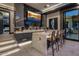 Contemporary bar with marble top and sleek cabinetry at 7223 N Black Rock Trl, Paradise Valley, AZ 85253