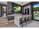 Home bar with marble countertop and seating, opens to backyard at 7223 N Black Rock Trl, Paradise Valley, AZ 85253