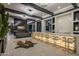 Modern bar with lit onyx countertop and barstools at 7223 N Black Rock Trl, Paradise Valley, AZ 85253