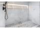 Modern shower with marble tile, linear drain, and LED lighting at 7223 N Black Rock Trl, Paradise Valley, AZ 85253